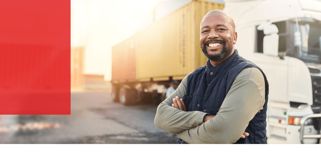 man standing in front of his truck smiling