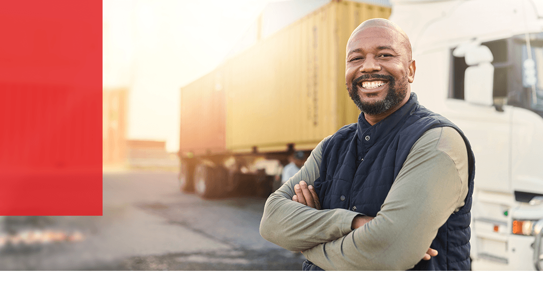 man standing in front of his truck smiling