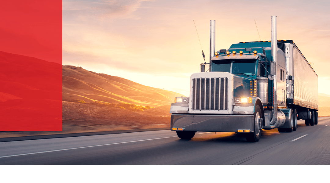 truck driving with a sunset behind them