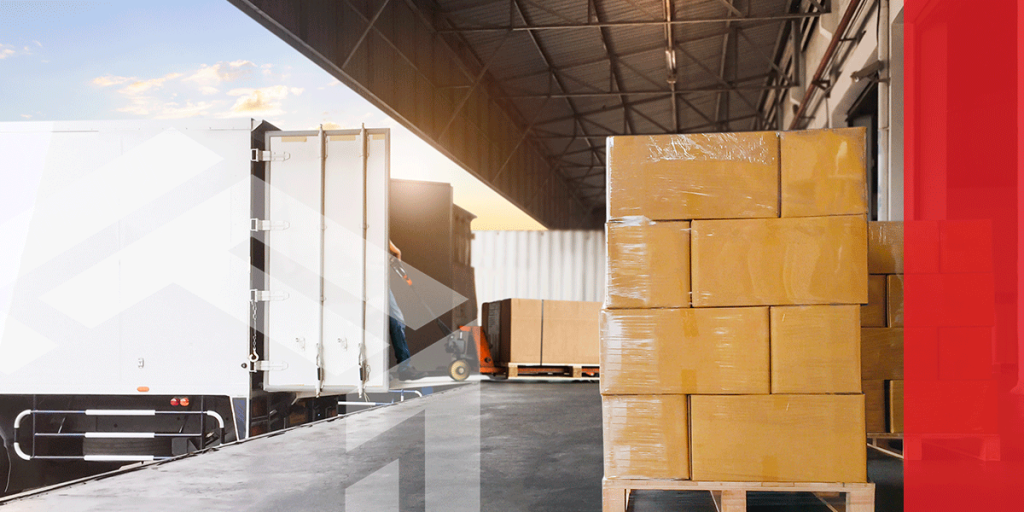 A pallet of wrapped boxes going onto a truck for shipment.