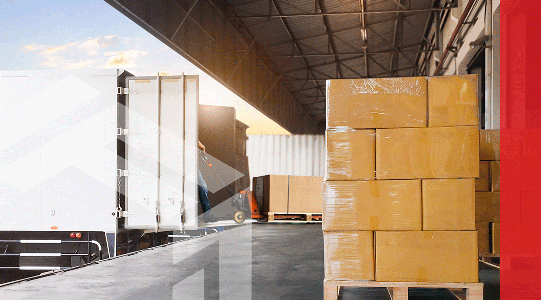 A pallet of wrapped boxes going onto a truck for shipment.