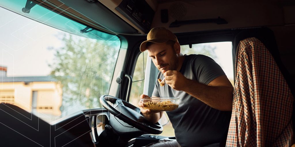 Truck driver eating a healthy meal on the road.