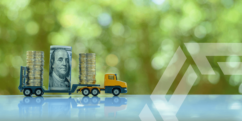 FactorLoads: Get paid immediately. A driver holding cash after using FactorLoads' services.