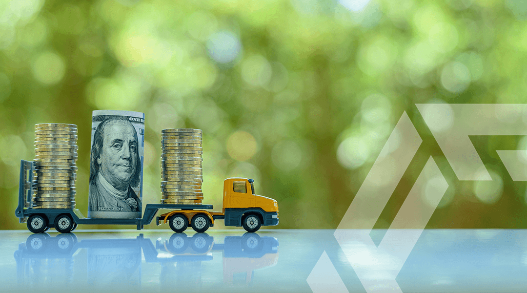 FactorLoads: Get paid immediately. A driver holding cash after using FactorLoads' services.